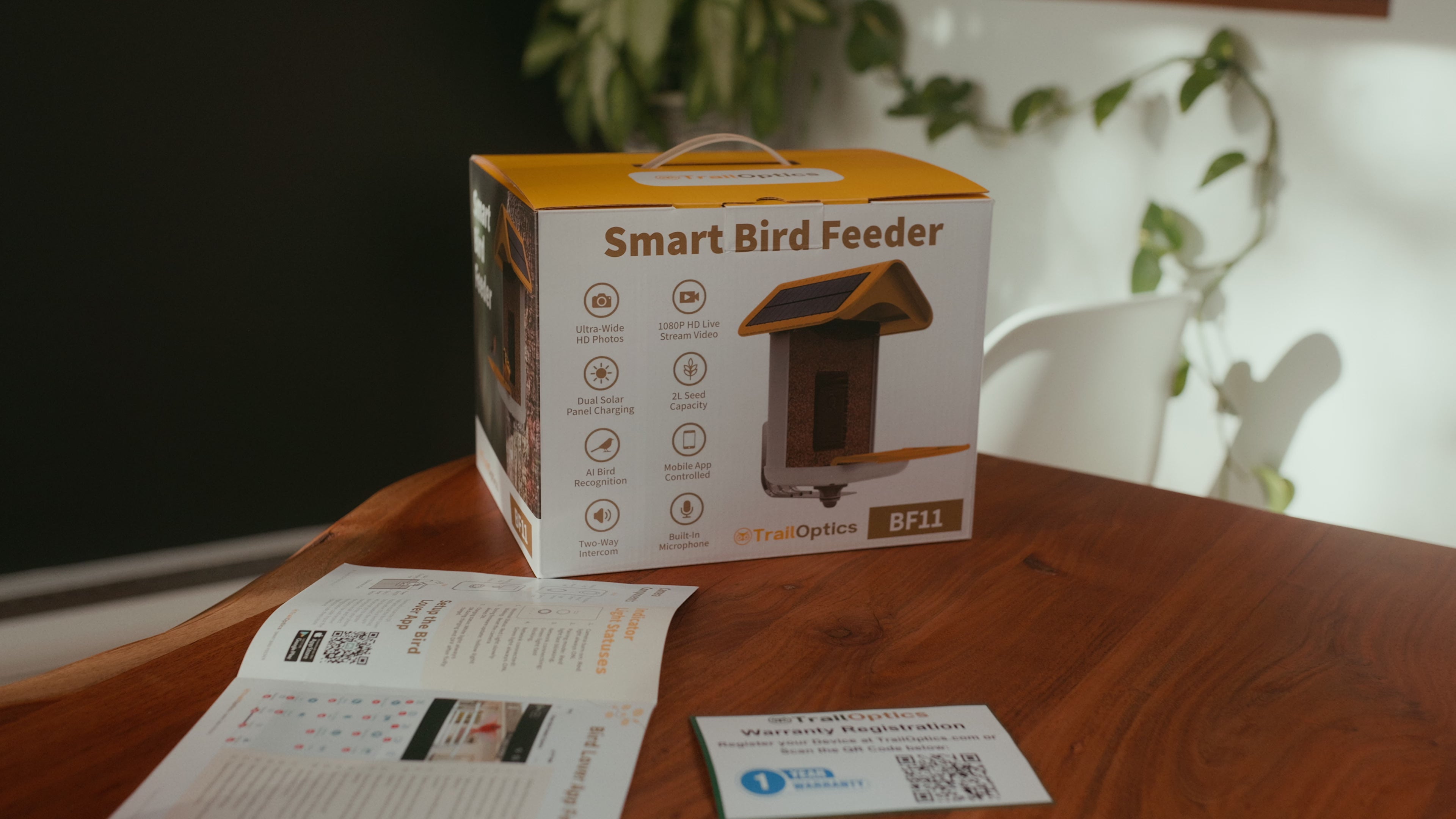 Easy to use smart bird feeder with camera and solar panels advertisement in a nature-filled home